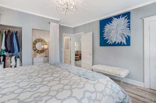354 Frieda Ave, Kirkwood, MO 63122 - bedroom featuring wood finished floors, crown molding, a chandelier, and a closet