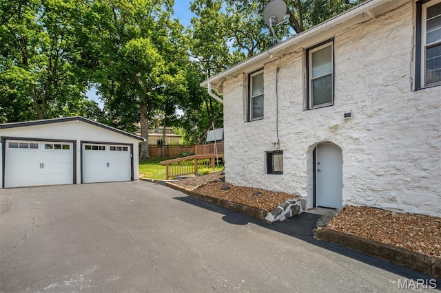 354 Frieda Ave, Kirkwood, MO 63122 - view of side of home with an outbuilding, stone siding, and a detached garage
