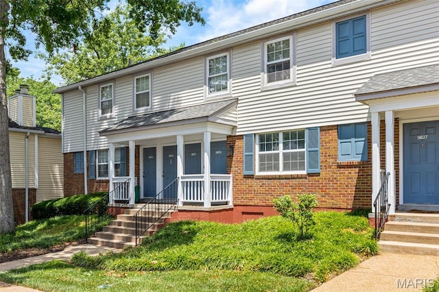 9029 N Swan Cir, Saint Louis, MO 63144 - traditional home featuring brick siding and a porch