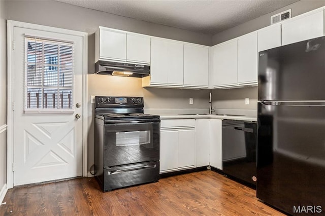 9029 N Swan Cir, Saint Louis, MO 63144 - kitchen featuring black appliances, under cabinet range hood, light countertops, and white cabinets
