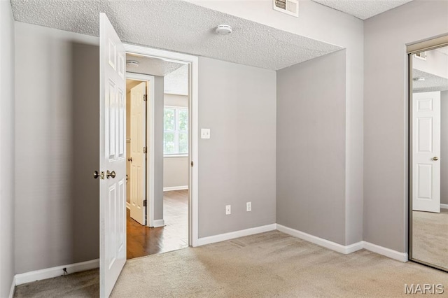 9029 N Swan Cir, Saint Louis, MO 63144 - carpeted empty room featuring a textured ceiling and a smoke detector