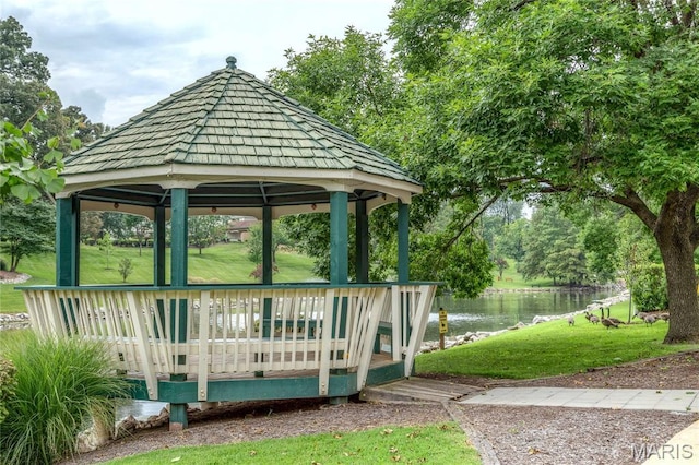 9029 N Swan Cir, Saint Louis, MO 63144 - view of green lawn with a gazebo, a deck with water view, and view of wooded area