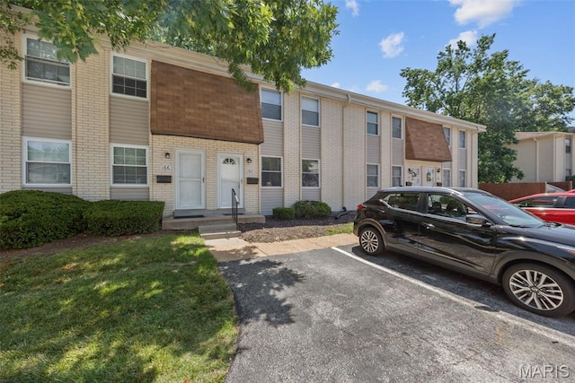 164 Burtonwood Dr, Ballwin, MO 63011 - view of front facade featuring uncovered parking and brick siding