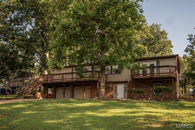 1688 Notre Dame Dr, Bonne Terre, MO 63628 - rear view of property with a deck, a lawn, an attached garage, and brick siding