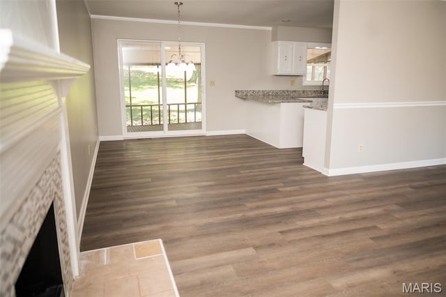 1688 Notre Dame Dr, Bonne Terre, MO 63628 - unfurnished living room featuring a chandelier, ornamental molding, and dark wood-type flooring