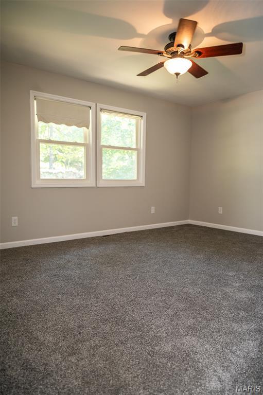 1688 Notre Dame Dr, Bonne Terre, MO 63628 - spare room featuring a ceiling fan and dark colored carpet