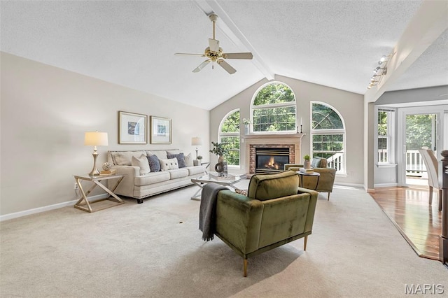 3164 Willow Bend Dr, Saint Charles, MO 63303 - carpeted living area with a glass covered fireplace, a textured ceiling, and a ceiling fan