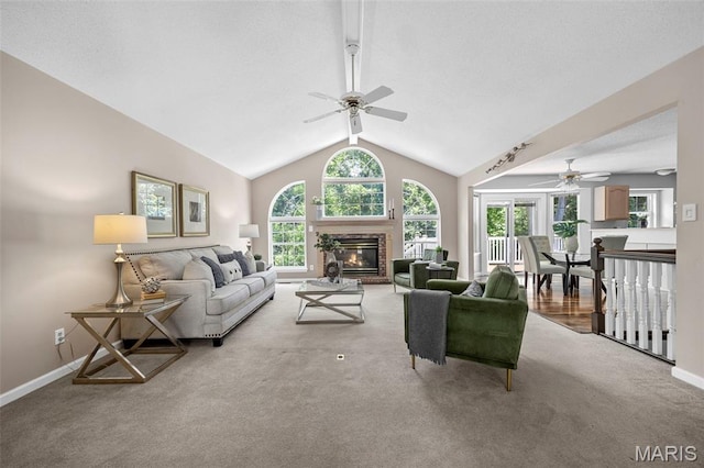 3164 Willow Bend Dr, Saint Charles, MO 63303 - living room featuring a ceiling fan, carpet flooring, a glass covered fireplace, and lofted ceiling