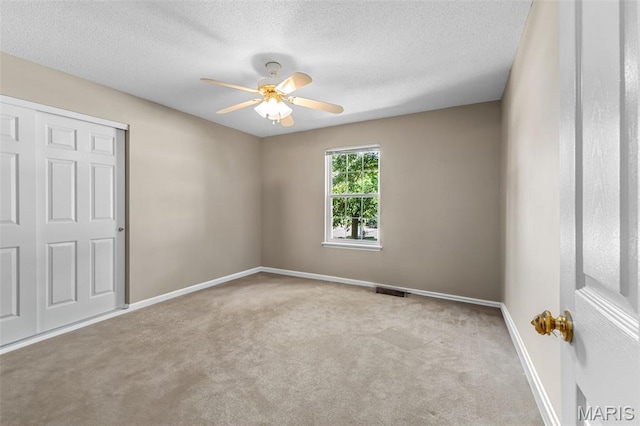 3164 Willow Bend Dr, Saint Charles, MO 63303 - unfurnished bedroom with carpet flooring, a textured ceiling, and ceiling fan