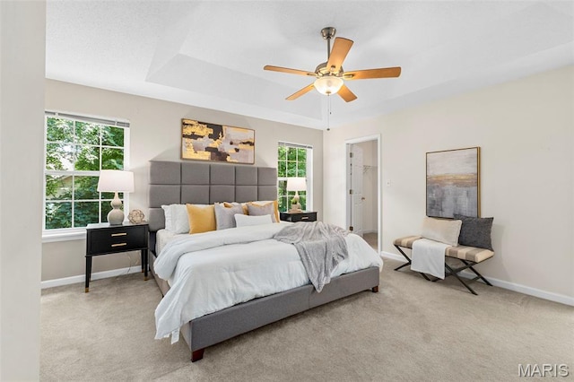 3164 Willow Bend Dr, Saint Charles, MO 63303 - carpeted bedroom with multiple windows, ceiling fan, a walk in closet, and a raised ceiling