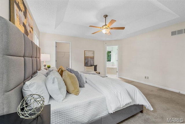 3164 Willow Bend Dr, Saint Charles, MO 63303 - bedroom featuring a raised ceiling, a walk in closet, carpet, ensuite bath, and a ceiling fan
