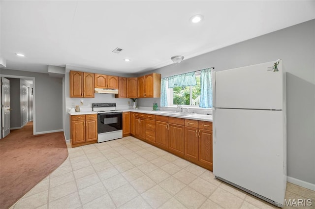 3164 Willow Bend Dr, Saint Charles, MO 63303 - kitchen featuring white appliances, under cabinet range hood, light countertops, brown cabinets, and recessed lighting