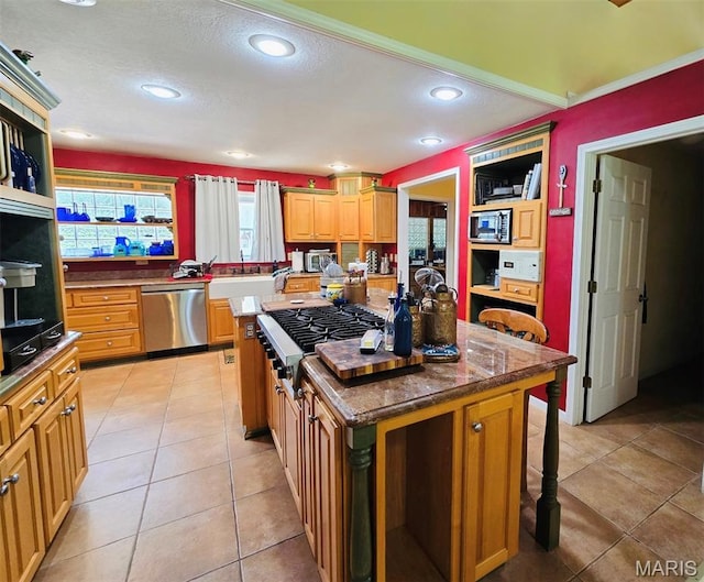 202 Maple, Licking, MO 65542 - kitchen featuring stainless steel appliances, a center island, a breakfast bar area, light tile patterned floors, and recessed lighting