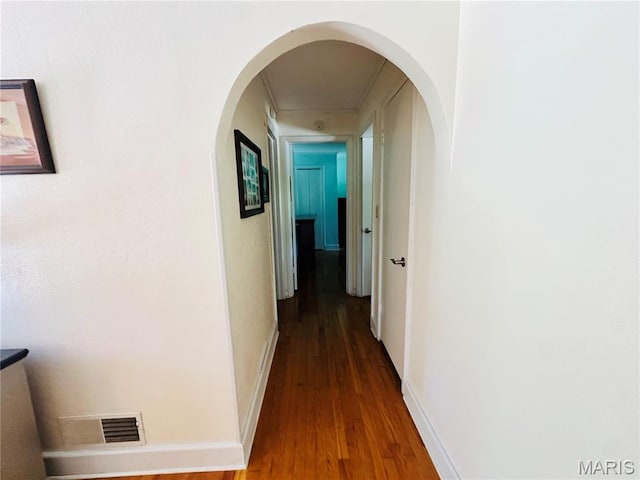 202 Maple, Licking, MO 65542 - corridor with wood finished floors and arched walkways