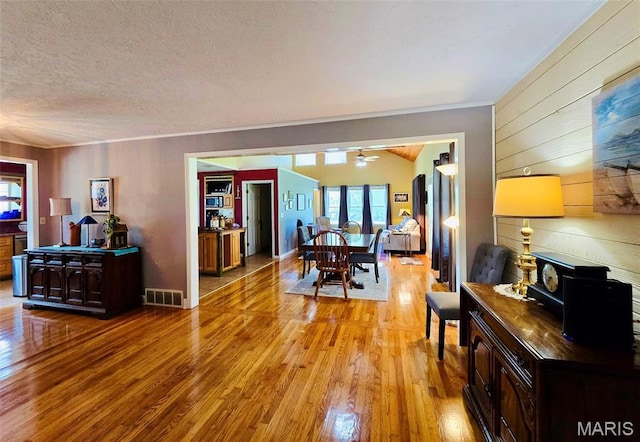 202 Maple, Licking, MO 65542 - dining room with light wood-style flooring, plenty of natural light, ceiling fan, a textured ceiling, and crown molding