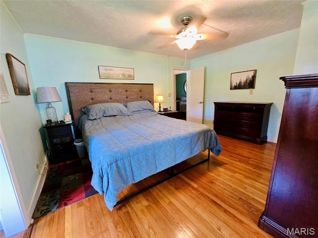 202 Maple, Licking, MO 65542 - bedroom featuring wood finished floors, crown molding, a ceiling fan, and a textured ceiling