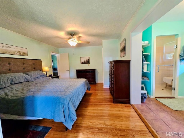 202 Maple, Licking, MO 65542 - bedroom with wood finished floors, a textured ceiling, and ceiling fan