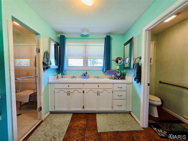 202 Maple, Licking, MO 65542 - bathroom with a stall shower, double vanity, a textured ceiling, and tile patterned flooring