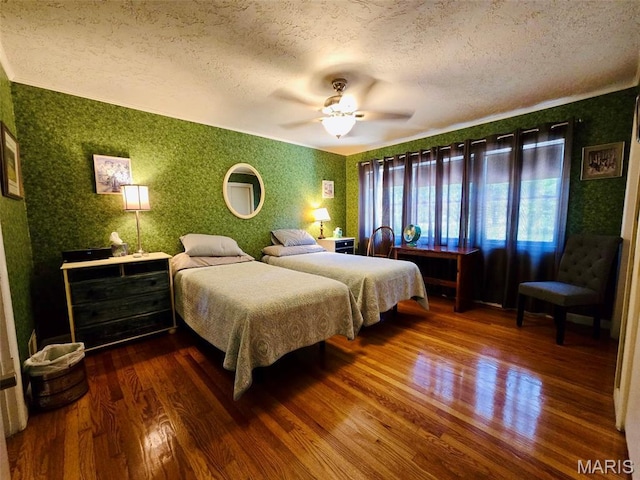 202 Maple, Licking, MO 65542 - bedroom featuring wallpapered walls, dark wood-style flooring, a textured ceiling, and a ceiling fan