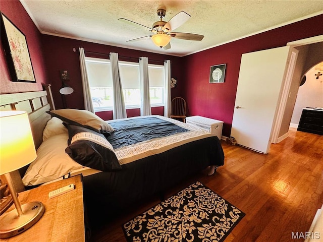 202 Maple, Licking, MO 65542 - bedroom featuring a textured ceiling, wood finished floors, ceiling fan, and ornamental molding