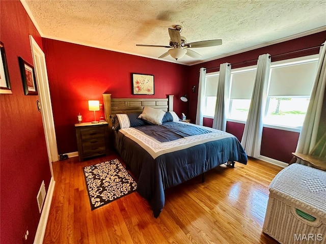 202 Maple, Licking, MO 65542 - bedroom with a textured ceiling, wood finished floors, a ceiling fan, and ornamental molding