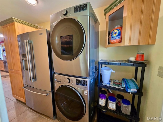 202 Maple, Licking, MO 65542 - washroom with stacked washer / dryer, light tile patterned floors, and cabinet space