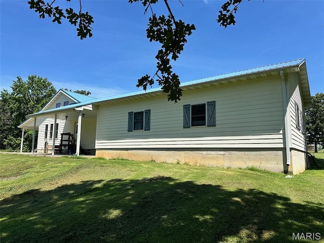 202 Maple, Licking, MO 65542 - back of house featuring a lawn and a metal roof