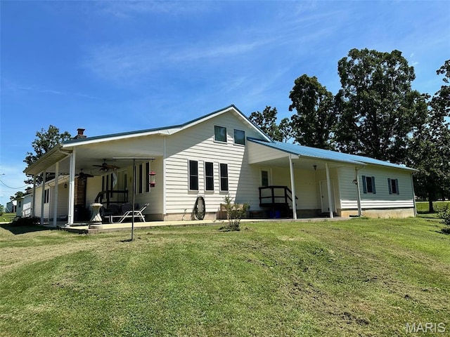 202 Maple, Licking, MO 65542 - rear view of house featuring a ceiling fan, a lawn, and a patio