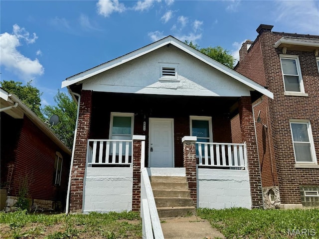 4652 Shirley Pl, Saint Louis, MO 63115 - view of front facade featuring covered porch and brick siding