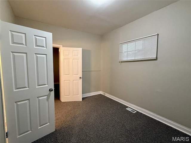 4652 Shirley Pl, Saint Louis, MO 63115 - empty room featuring dark carpet and baseboards