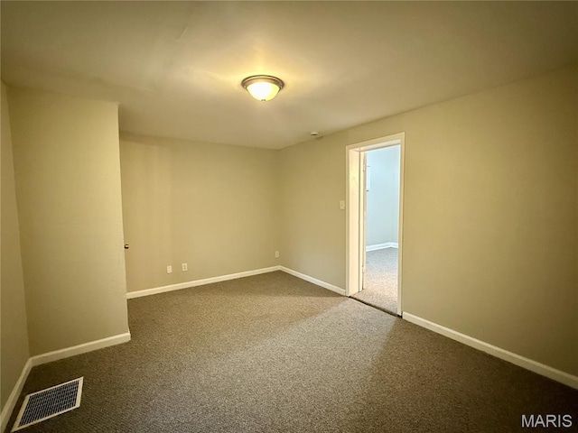 4652 Shirley Pl, Saint Louis, MO 63115 - spare room featuring dark colored carpet and baseboards