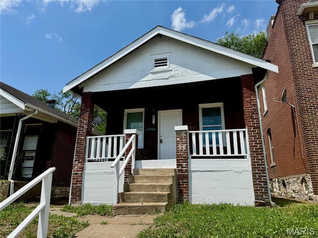 4652 Shirley Pl, Saint Louis, MO 63115 - bungalow featuring covered porch and brick siding