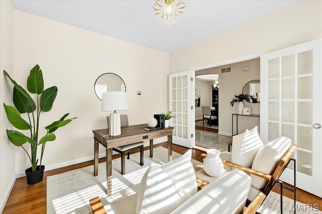 334 Lauren Lndg, Ballwin, MO 63021 - office area with french doors, wood finished floors, arched walkways, and a chandelier