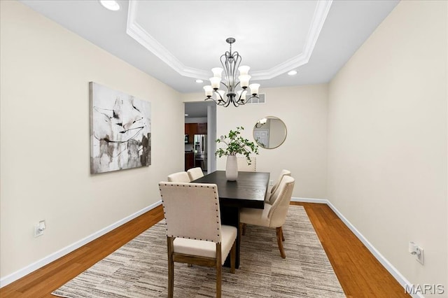 334 Lauren Lndg, Ballwin, MO 63021 - dining area with wood finished floors, a chandelier, ornamental molding, recessed lighting, and a tray ceiling