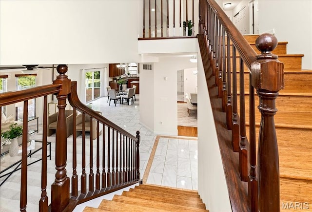 334 Lauren Lndg, Ballwin, MO 63021 - stairway featuring marble look tiles and a high ceiling