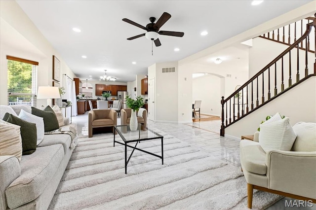 334 Lauren Lndg, Ballwin, MO 63021 - living area featuring stairway, arched walkways, ceiling fan, a chandelier, and recessed lighting