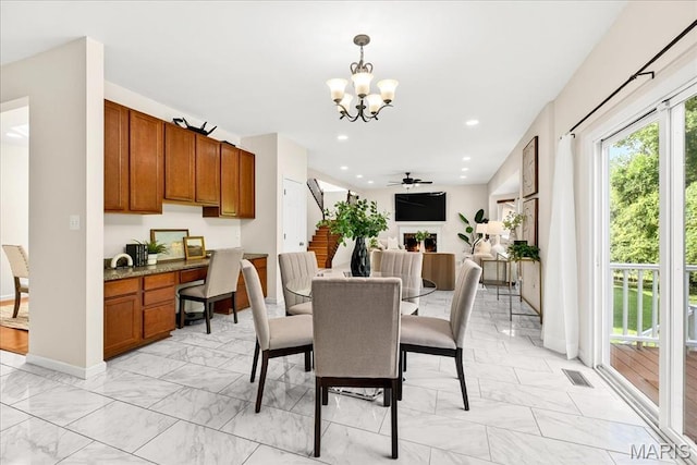 334 Lauren Lndg, Ballwin, MO 63021 - dining area featuring light marble finish flooring, a chandelier, stairs, built in study area, and recessed lighting
