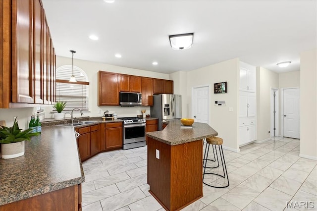 334 Lauren Lndg, Ballwin, MO 63021 - kitchen with appliances with stainless steel finishes, light marble finish flooring, a breakfast bar area, dark countertops, and a center island
