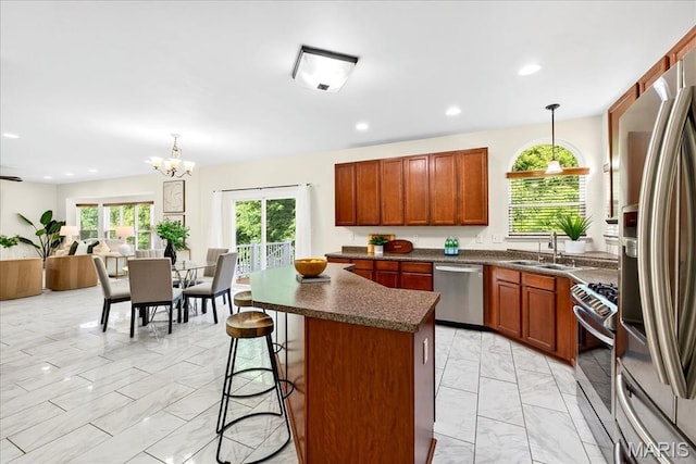 334 Lauren Lndg, Ballwin, MO 63021 - kitchen featuring light marble finish flooring, stainless steel appliances, dark countertops, a center island, and recessed lighting
