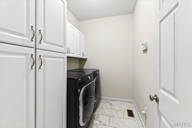 334 Lauren Lndg, Ballwin, MO 63021 - laundry room with washer and dryer, cabinet space, and light marble finish floors