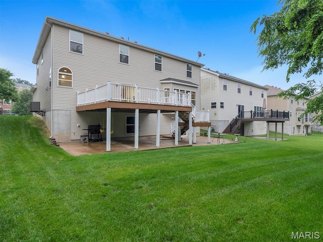 334 Lauren Lndg, Ballwin, MO 63021 - back of property featuring stairs, a patio, a wooden deck, and a lawn