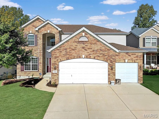 334 Lauren Lndg, Ballwin, MO 63021 - traditional-style home featuring a garage, brick siding, concrete driveway, and a front yard