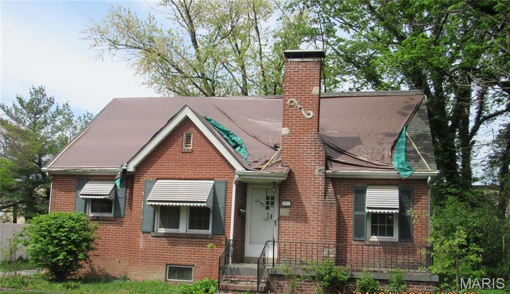 401 S High St, Belleville, IL 62220 - view of front facade with brick siding and a chimney