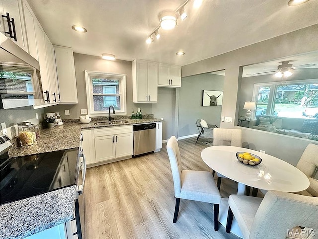 1226 Oakleaf Dr, Saint Louis, MO 63119 - kitchen with stainless steel appliances, open floor plan, white cabinetry, light wood-style floors, and recessed lighting