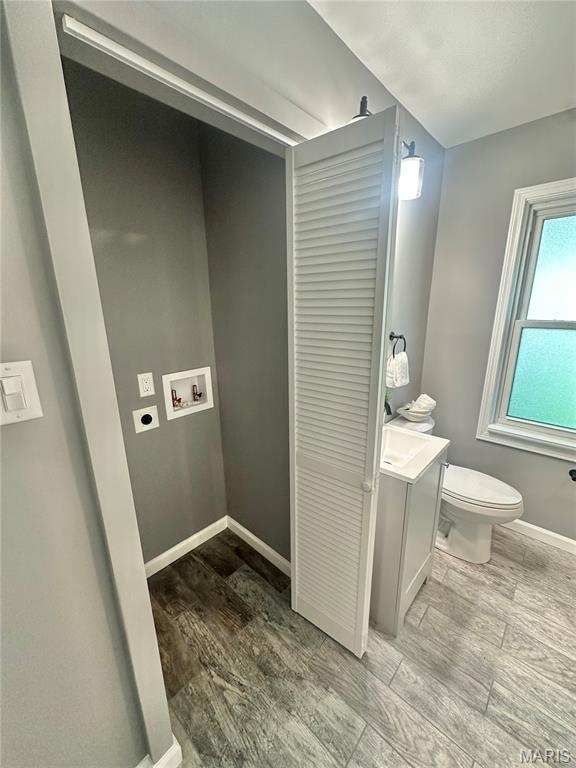 1226 Oakleaf Dr, Saint Louis, MO 63119 - bathroom with wood finished floors and vanity