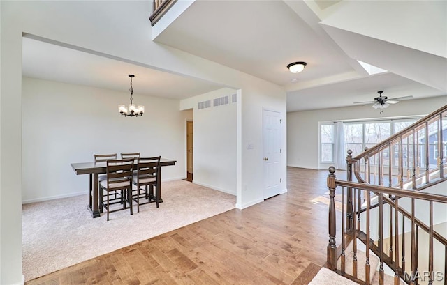 17603 Hitching Post Ct, Eureka, MO 63025 - dining space featuring light wood finished floors, stairway, a chandelier, ceiling fan, and a skylight