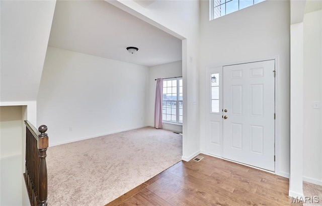 17603 Hitching Post Ct, Eureka, MO 63025 - carpeted entryway featuring wood finished floors and a high ceiling