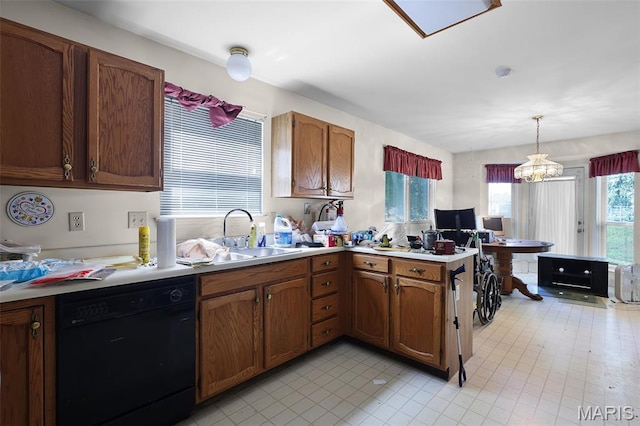 3816 Keeneland Ct, Florissant, MO 63034 - kitchen featuring dishwasher, plenty of natural light, hanging light fixtures, and brown cabinetry