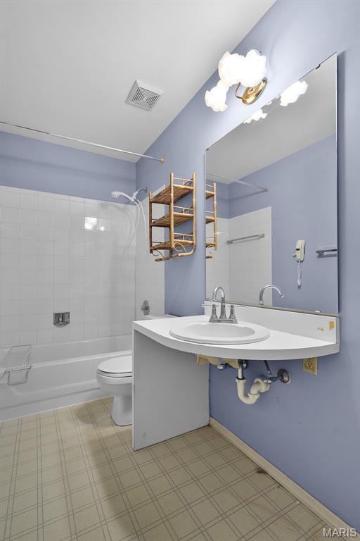 3816 Keeneland Ct, Florissant, MO 63034 - bathroom featuring tub / shower combination, tile patterned floors, and a chandelier