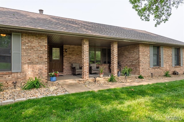 616 E Brentmoor Dr, Troy, IL 62294 - doorway to property featuring brick siding, a shingled roof, and a yard
